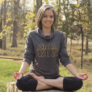Susan Quilty sitting outside in lotus yoga pose 